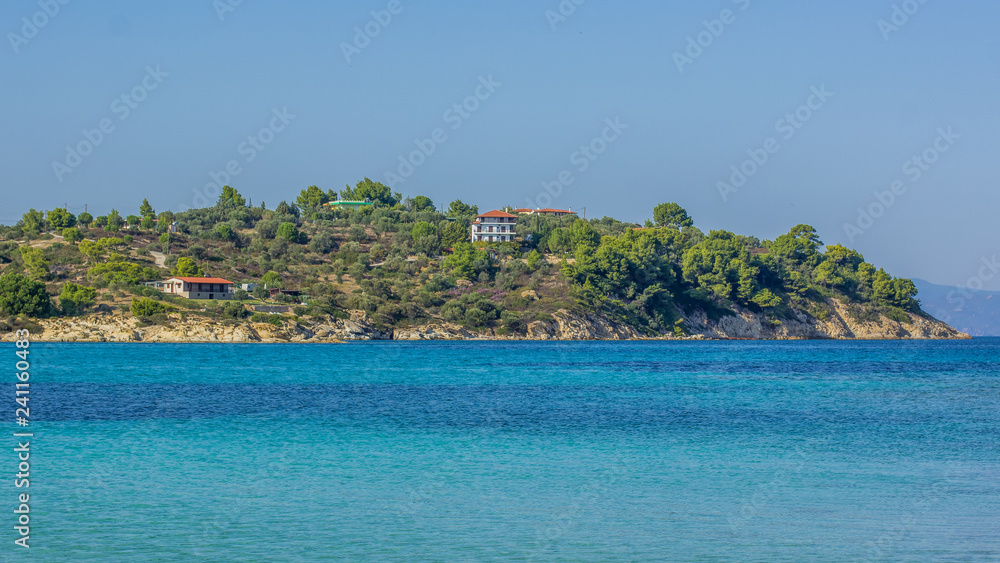 tropic island coast in park trees natural environment and apartment house near to beach in Mediterranean sea vivid  blue water lagoon 