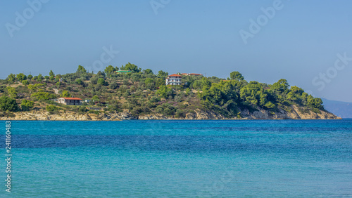 tropic island coast in park trees natural environment and apartment house near to beach in Mediterranean sea vivid blue water lagoon 