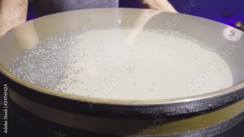 Woman is playing meditative instrument ocean drum in a dark meditation room. Close-up.