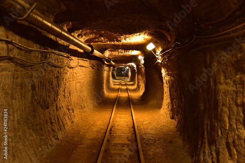 Underground workings in salt mine with pipelines and railway