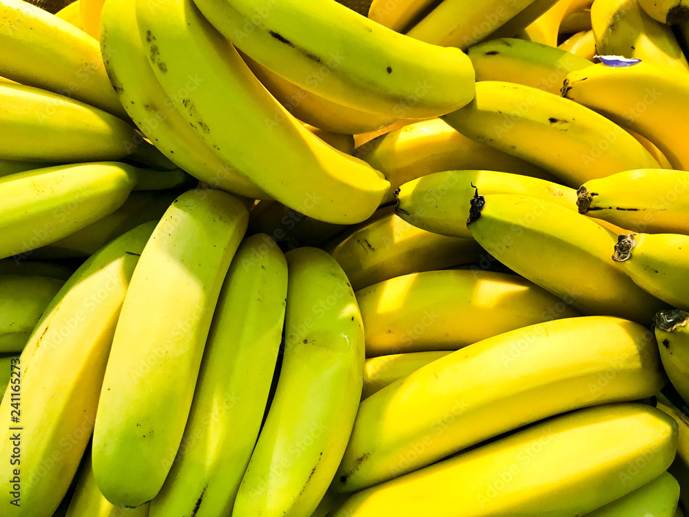 Beautiful yellow natural sweet tasty ripe soft round big bright bananas. Texture, background