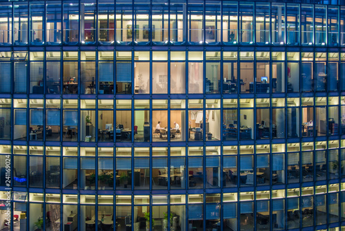 skyscraper Office windows and office worker by night