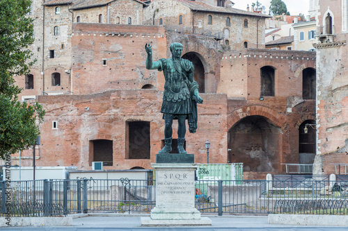 Bronze monumental statue of the Caesar Nervae Trajan on background Forum of Caesar Nervae, Rome, Italy photo