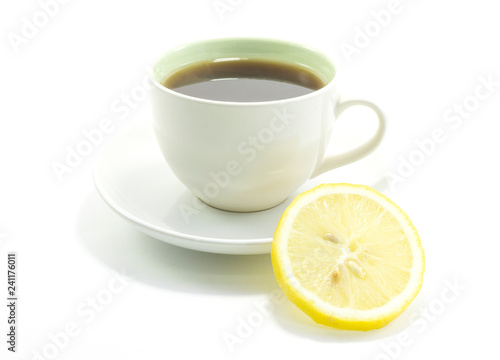 Lemon tea in a hot white glass on white background with copy space for your text..