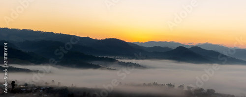Mountain and foggy at morning time with orange sky, beautiful landscape in the thailand © AungMyo