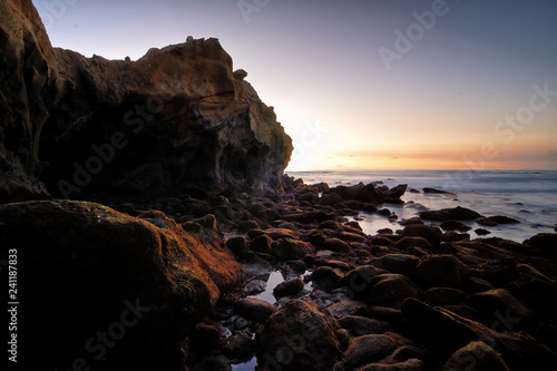 Rocky geological formations of the Laguna shore as sun sets and the blue hour sets in.