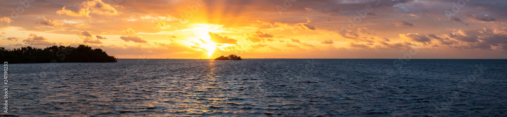 Dramatic Panoramic view of a cloudy sunrise on a tropical Atlantic Ocean Coast. Taken in Plantation Key, Florida Keys, Florida, United States.