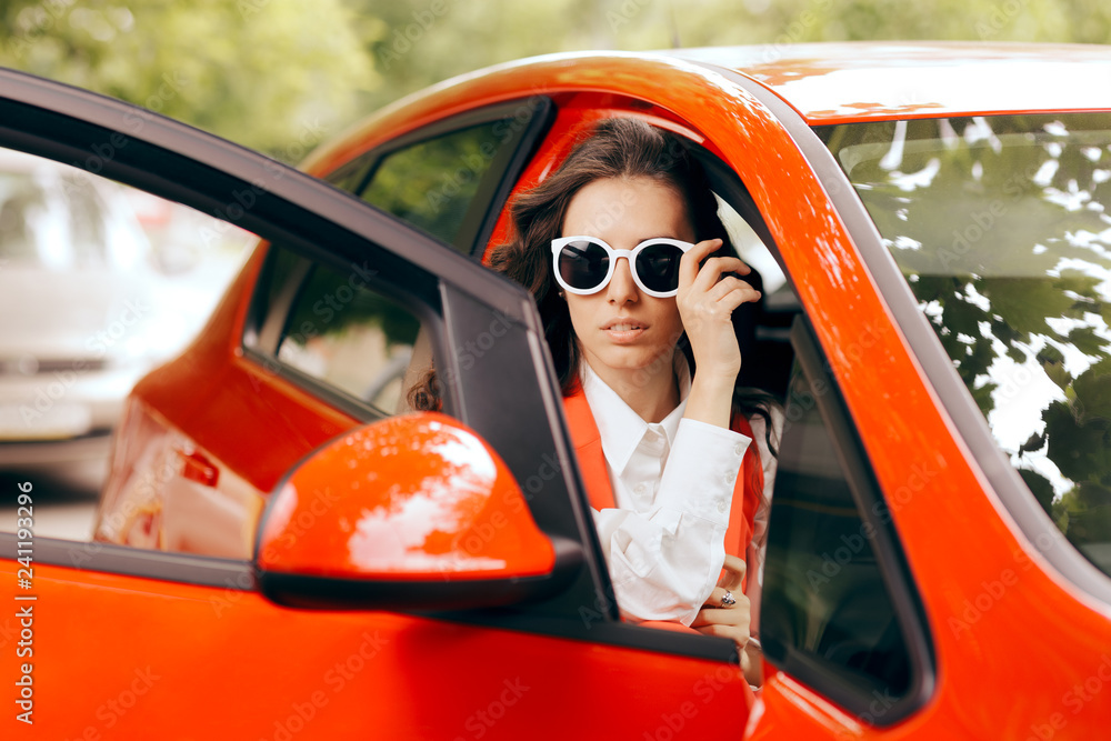 Naklejka premium Elegant Fashionable Stylish Woman in Red Car