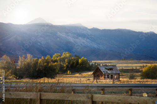 farm and barn in the utah mountain range at sunset