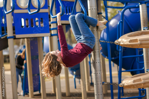 Girl Tween at Park Hanging from Monkey bars Playground