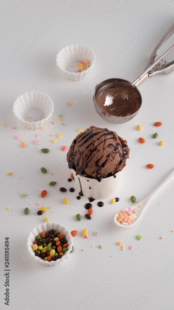 Chocolate ice cream scoop in white paper cup topping with chocolate ...