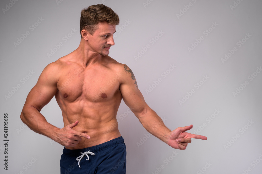 Muscular handsome bearded man shirtless and showing something Muscular handsome bearded man shirtless and showing something