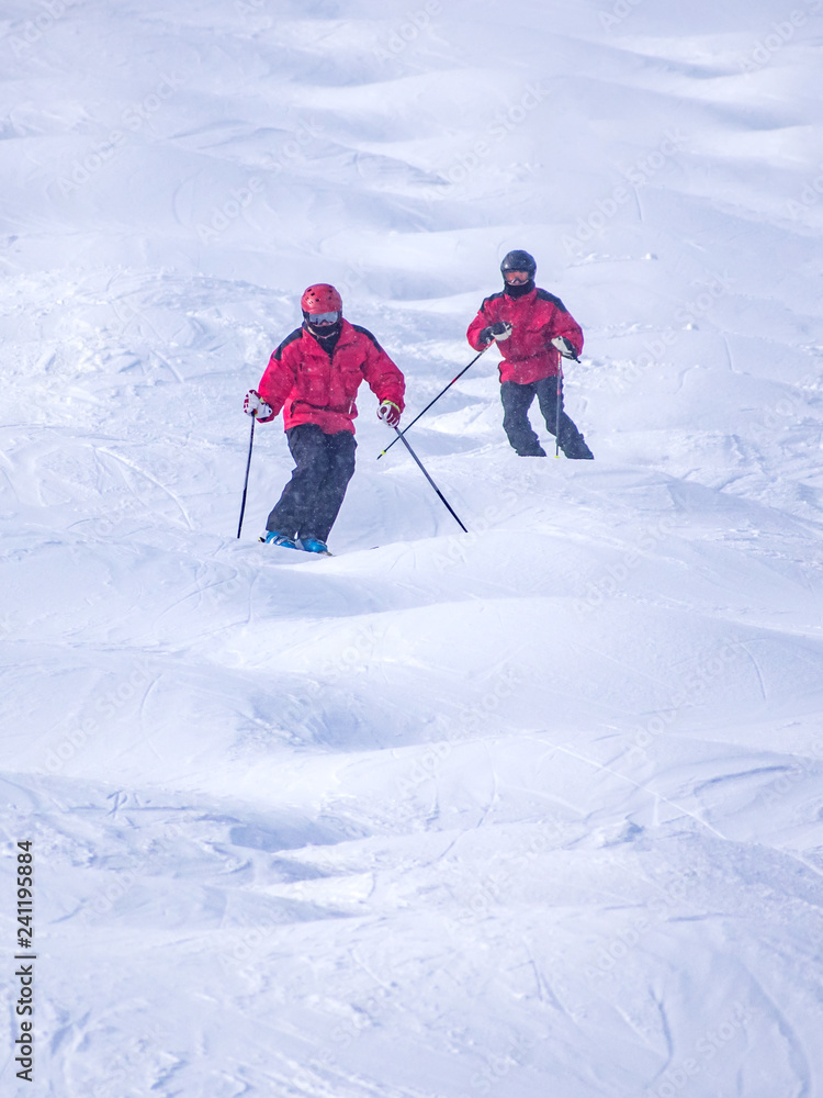 People are enjoying mogul skiing snow boarding