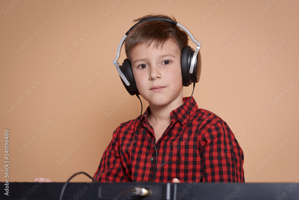 The portrait of a good-looking European boy on a peach background. He ...