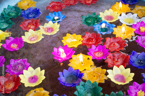 Ritual praying colorful flowers candle floating on water for pray buddha at temple of Thailand