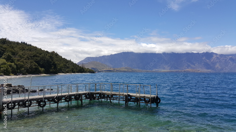 This is taken in Queenstown, New Zealand. The lake is crystal clear and blue. Many people come here to relax their boat and explore the lake waters.