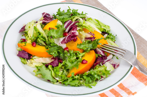 Salad with green leaves and persimmon