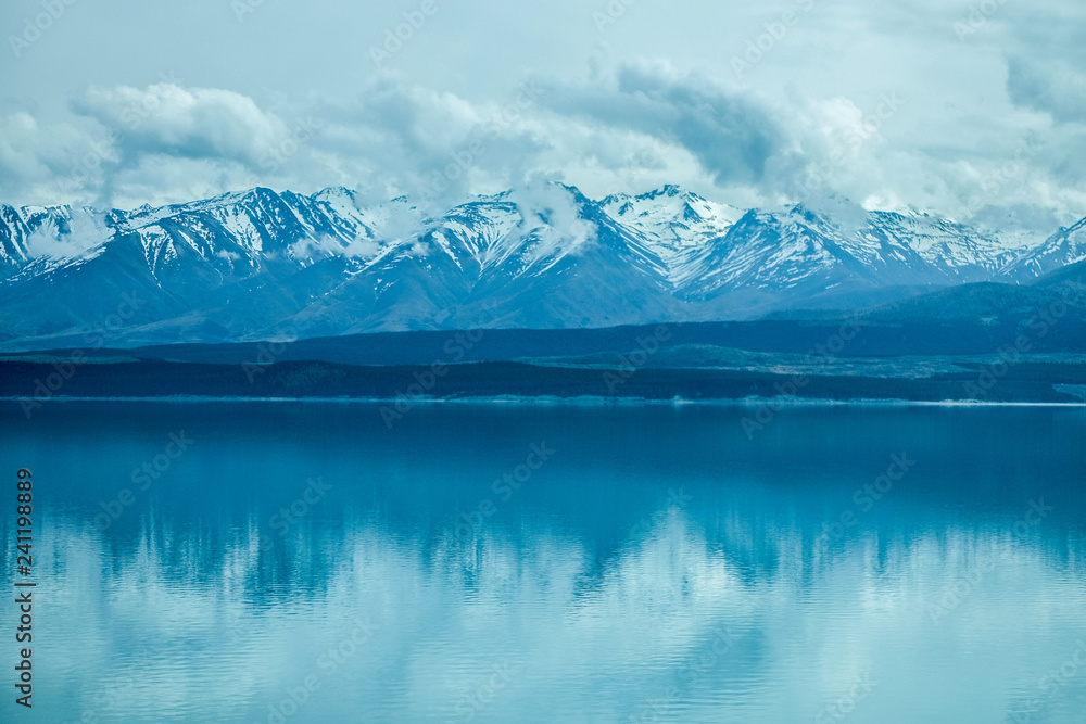 This photo is taken in Mt.cook of New Zealand. There are snow on the peak of the mountain. Below is beautiful lake reflecting the mountains .This is perfect for background or wallpaper. This photo is taken in Mt.cook of New Zealand. There are snow on the peak of the mountain. Below is beautiful lake reflecting the mountains .This is perfect for background or wallpaper.