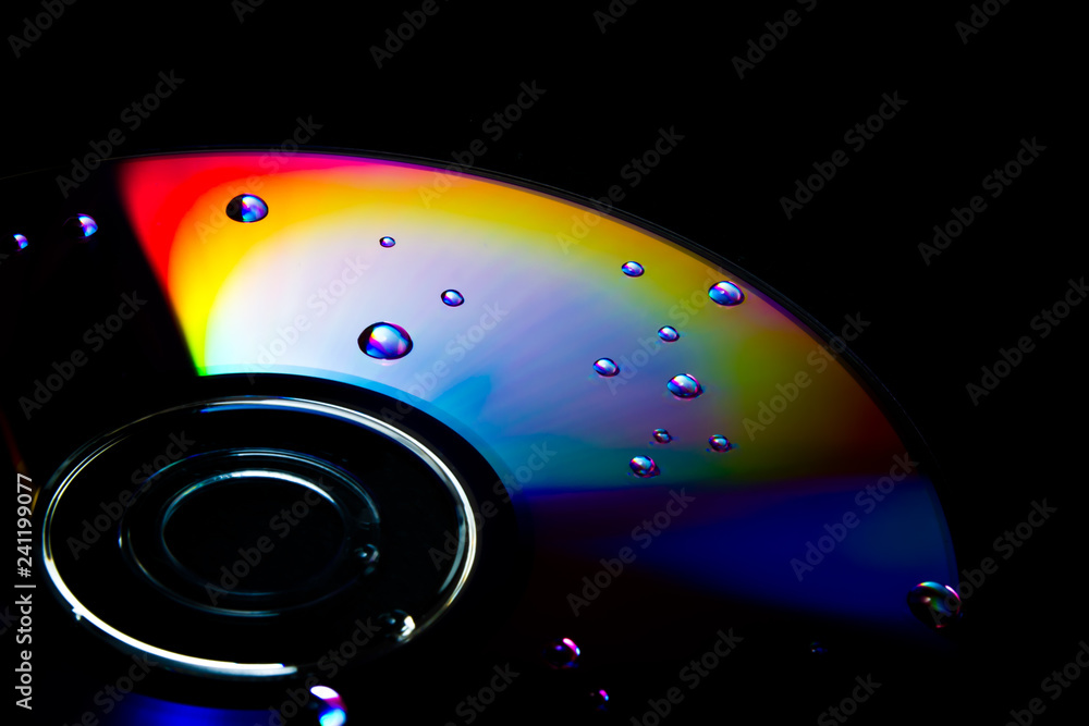 Sprinkle of water drops on a disc refracting beautiful rainbow colours Sprinkle of water drops on a disc refracting beautiful rainbow colours
