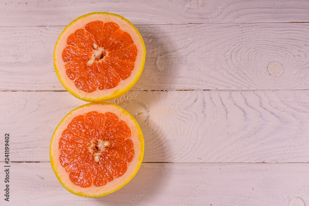 Ripe juicy grapefruit on a white wooden table. Top view Ripe juicy grapefruit on a white wooden table. Top view