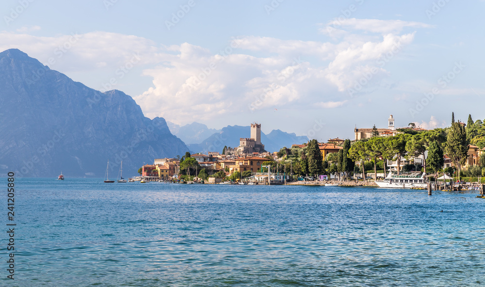 Idyllic coast in Italy: Blue water and a cute village at lago di garda, Malcesine