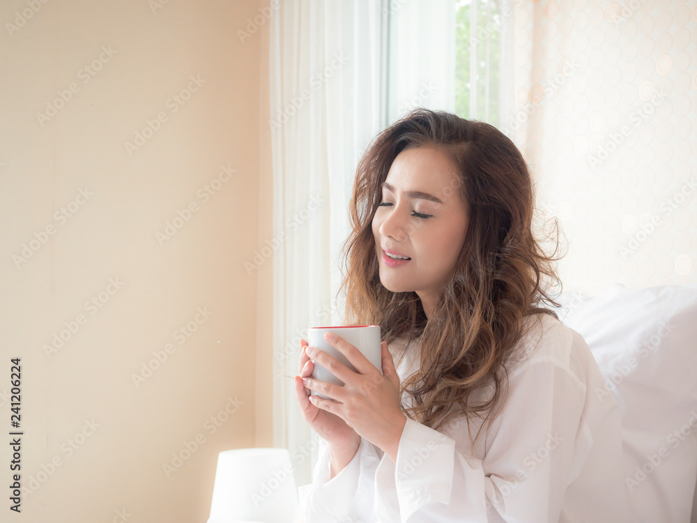 Beautiful woman is drinking coffee on the bed Beautiful woman is drinking coffee on the bed