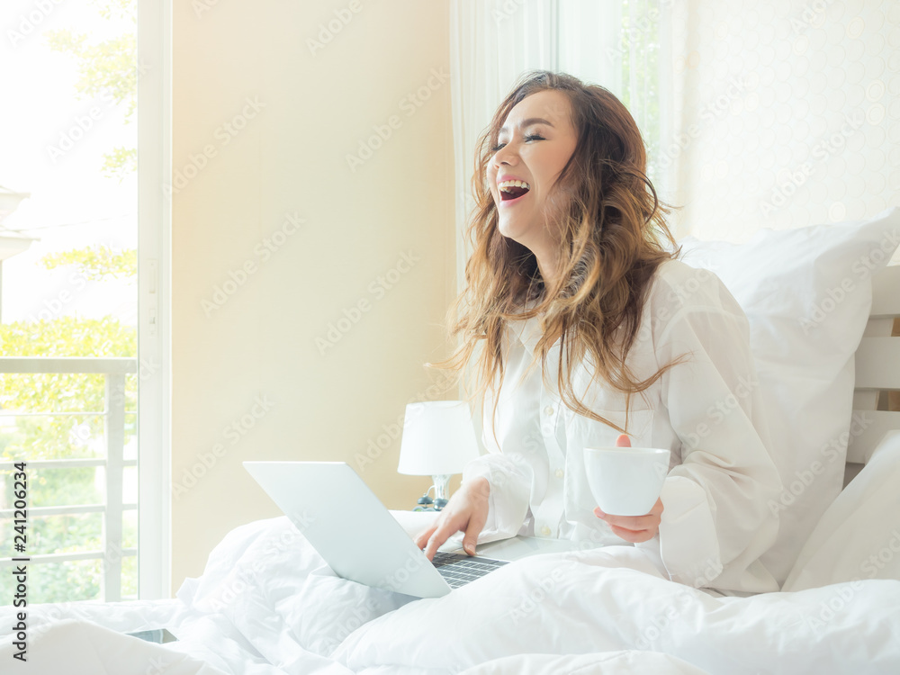 Beautiful woman is drinking coffee on the bed Beautiful woman is drinking coffee on the bed