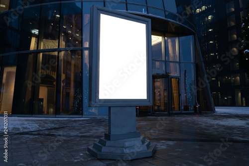 city billboard for outdoor advertising. metal glowing box. in the modern city in the evening.
