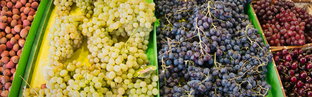 Exotic fruits. Market stall with variety of organic fruits. Colorful fruits in the marketplace. Bright summer background. Healthy, organic food.