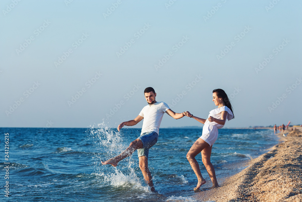 Obraz premium boy and girl fun splashing on the sea.