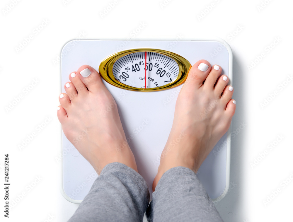 Toe Scale Female feet weighing scale on a white background isolation, top view ...
