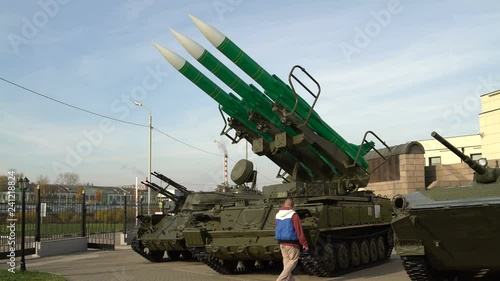 Man takes foto on the smartphone self-propelled launch system of the anti-aircraft missile system photo