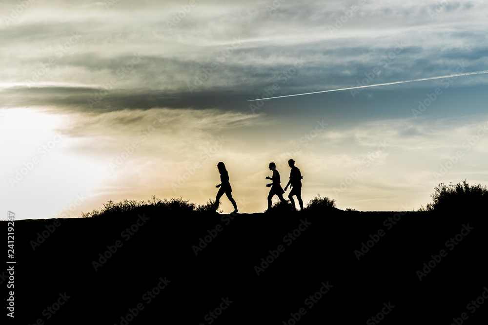 people walking in nature in sunset - symbol