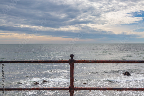 Looking out to sea over iron railings, at Ventnor on the Isle of Wight