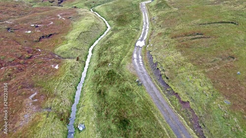 Single track at Loch Cuithir and Sgurr a Mhadaidh Ruadh - Hill of the Red Fox, Isle of Skye, Scotland photo