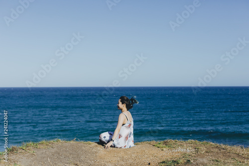 young woman sitting on the beach