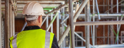 Obraz na płótnie Rear View of a Construction Worker on Building Site