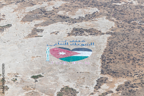 View from the walls of the fortress on the Jordanian flag painted in the shape of a heart on the surface of a nearby hill near Al Jaya city in Jordan photo