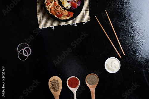 box with ready meal, noodles and salad with spices, copy space
