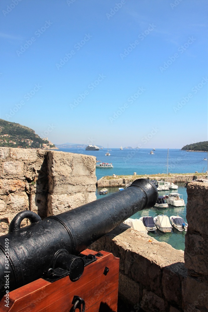 Loophole and old cannon on the fortress wall in Dubrovnik, Croatia.
