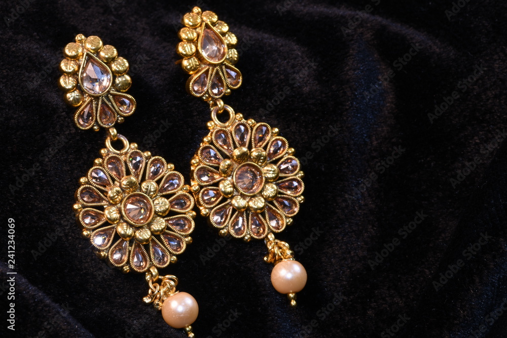 Pair of Golden earrings close up macro image on black background Pair of Golden earrings close up macro image on black background