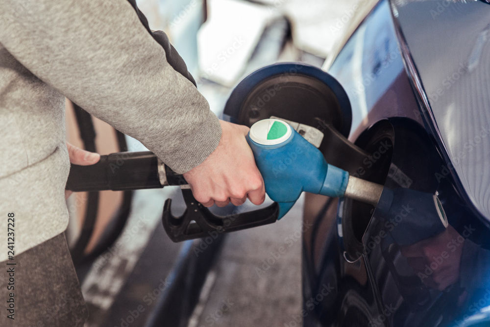 Hand putting gasoline