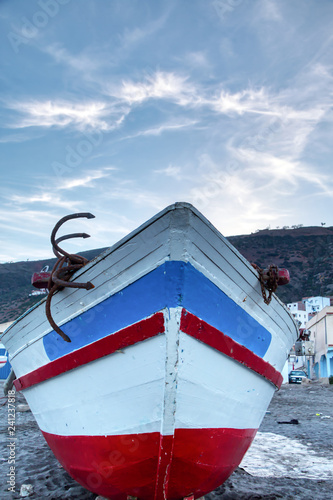 Fishing boat stranded on the beach of Oued Lao, a small coastal town in the province of Chefchaouen, in northern Morocco