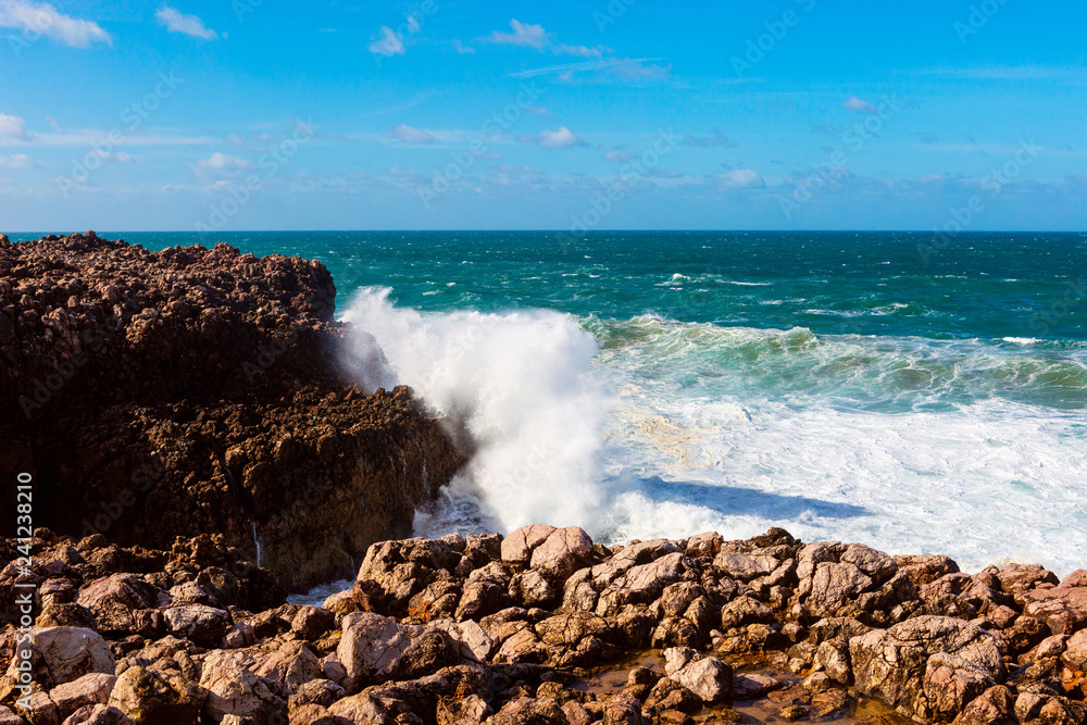 Sea waves hitting rocks cliff at Praia Da Bordeira, Portugal Sea waves hitting rocks cliff at Praia Da Bordeira, Portugal