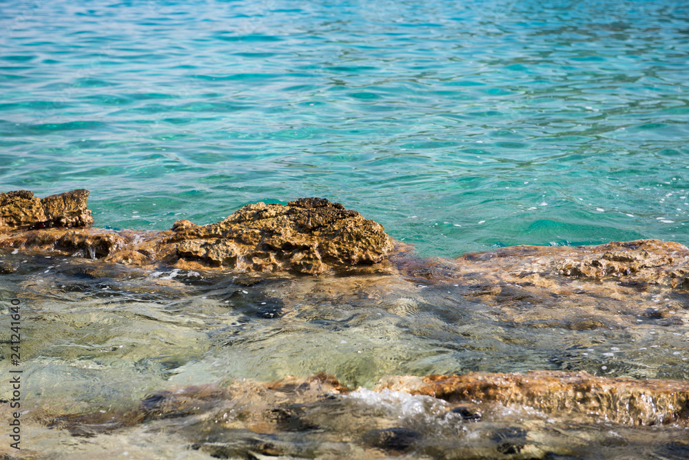 Sharp rocks, stones in a sea. Beautiful clean sea water. Sharp rocks, stones in a sea. Beautiful clean sea water.