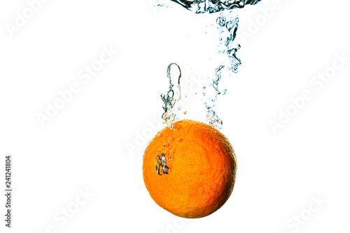 Fresh fruit dives into cold water with splash