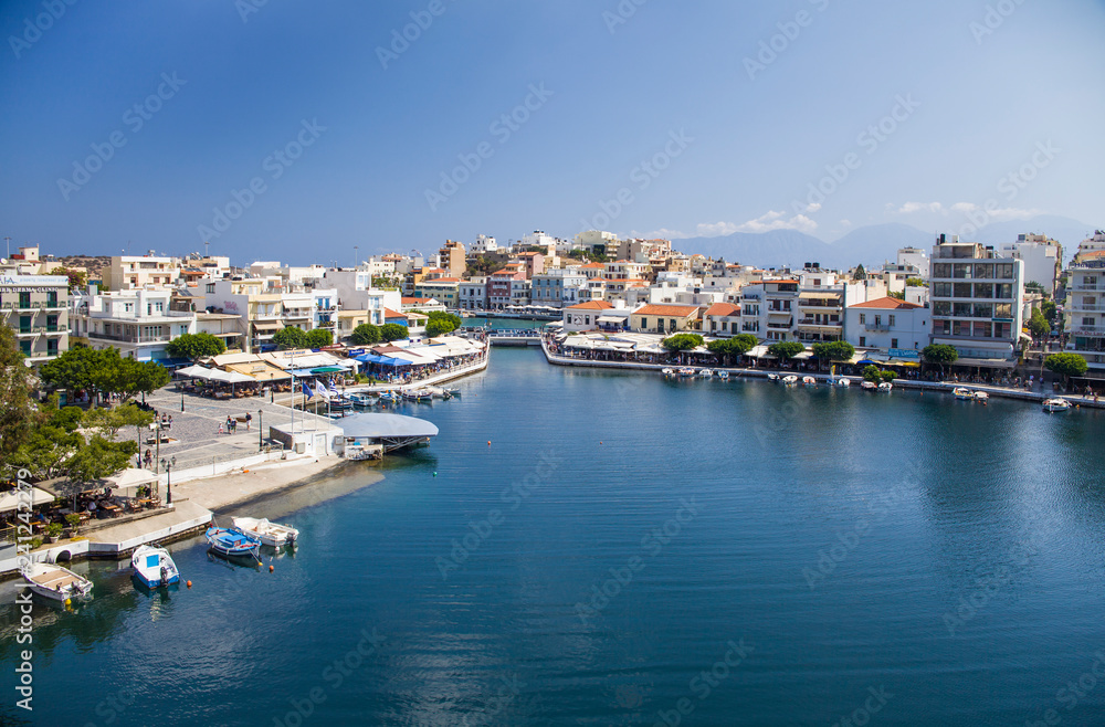 Lake in the middle of the city of Agios Nikolaos. A beautiful small town on the island of Crete, Greece. City architecture and tourist attractions.