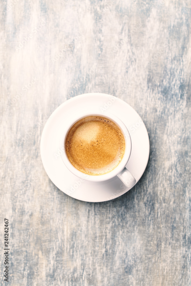 Fototapeta premium Cup of coffee on rustic wooden background. Top view. Copy space.