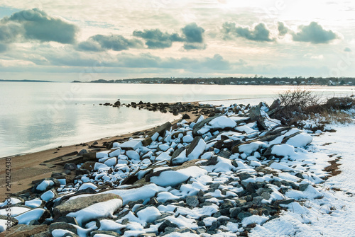 Snow-covered rocks along beach on Narrangansett Bay