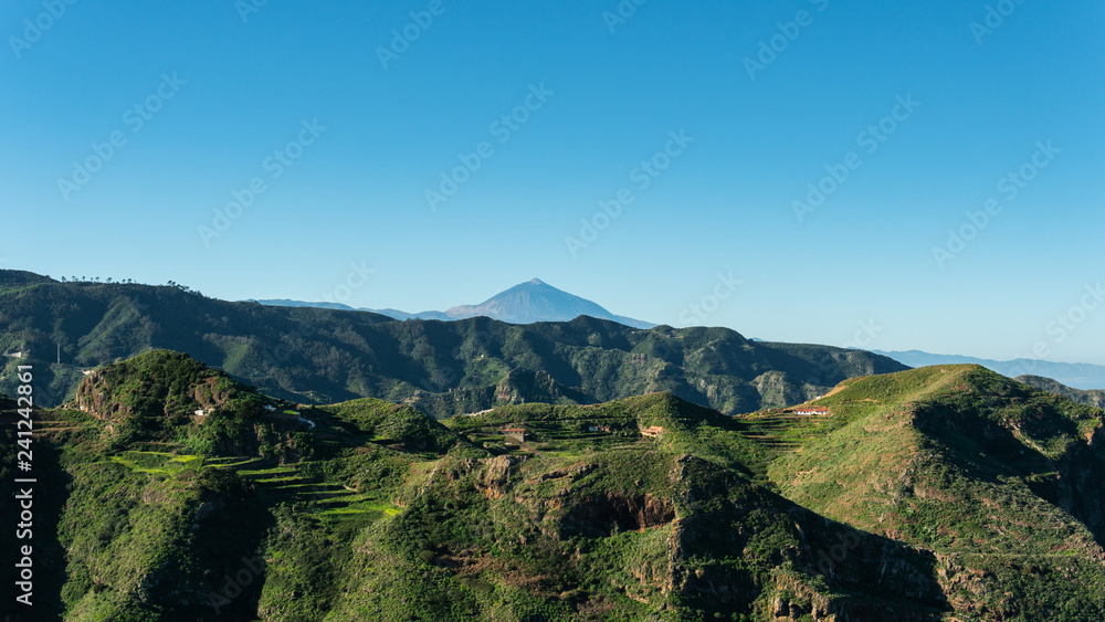 Green mountain and blue sky and volcano at the back